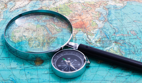compass-and-magnifying-glass-lie-on-the-topographic-map